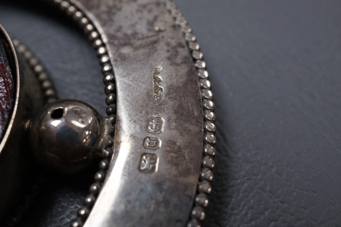 A late Victorian novelty silver and enamelled small photograph frame, modelled as a horseshoe, Birmingham, 1895, height 69mm together with a late 19th century Hanau white metal fish pin cushion(lacking cushion).